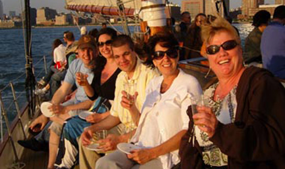 Friends out on a sailboat in NY Harbor for a wine pairing.