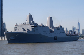 a military battleship sailing down the New York harbor