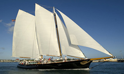 the schooner america 2.0 cruising down a river