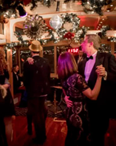 Couple dancing on a boat for a New Year's Eve Cruise