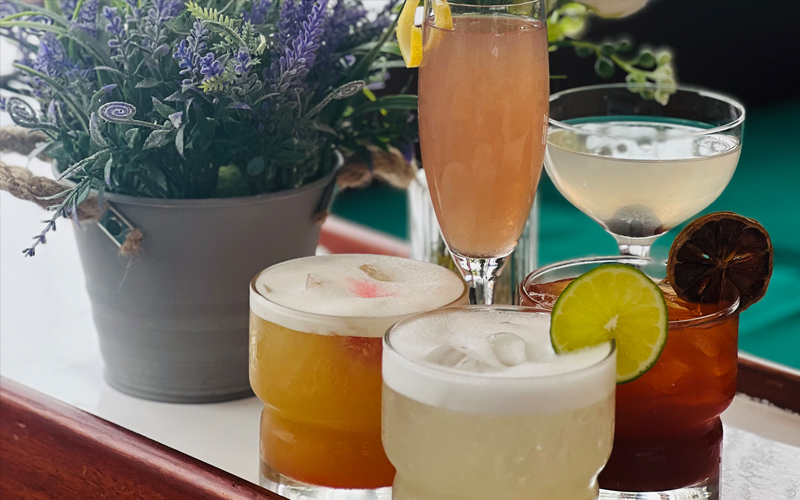 Four different cocktails on a table aboard a yacht
