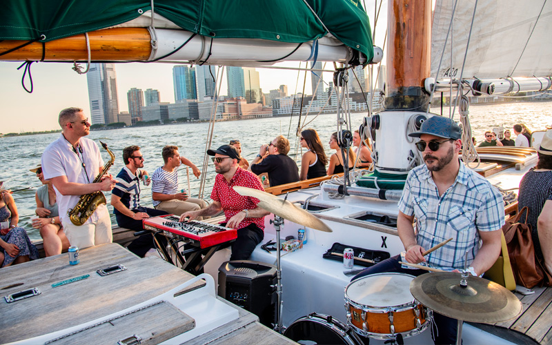 Three player Jazz Band on the deck of Schooner America 2.0 in NY Harbor with guests