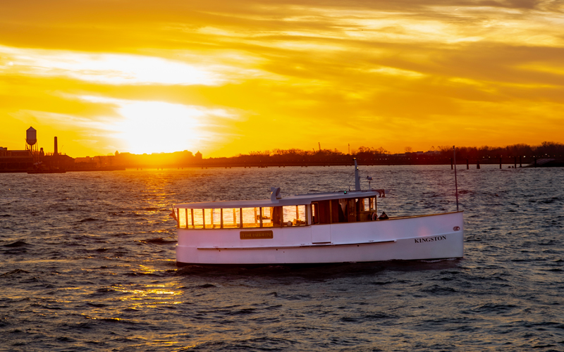 Yacht Kingston cruising through NY Harbor at Sunset