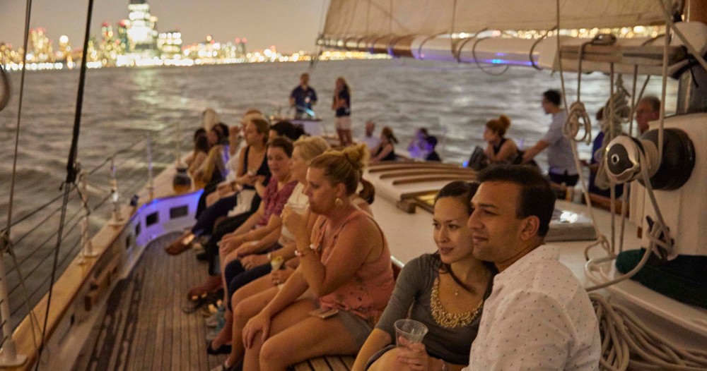 Guests sit aboard America 2.0 during the 4th of July Fireworks cruise, sailing down the Hudson
