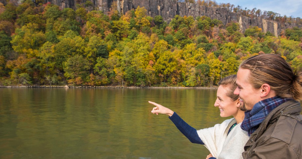 Couple admires the changing leaves cruising past the palisades