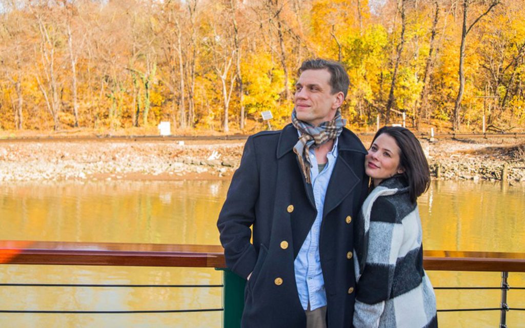Couple admires the fall foliage aboard Classic Harbor Line Yacht