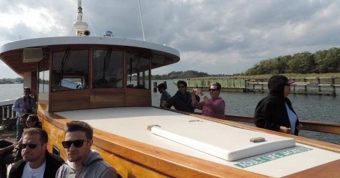 Guests sit on outer deck for AIANY Freshkills Park Cruise