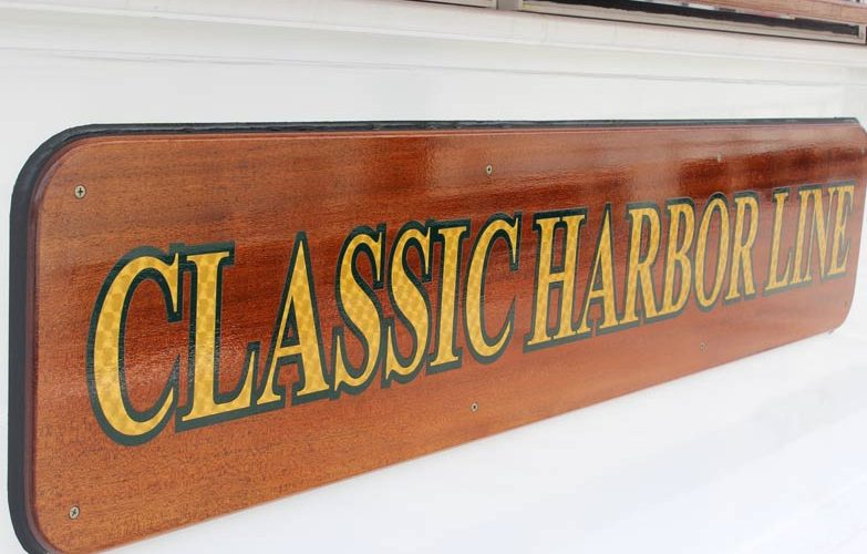 Classic Harbor Line gold leaf writing on the cabin top of Yacht Kingston