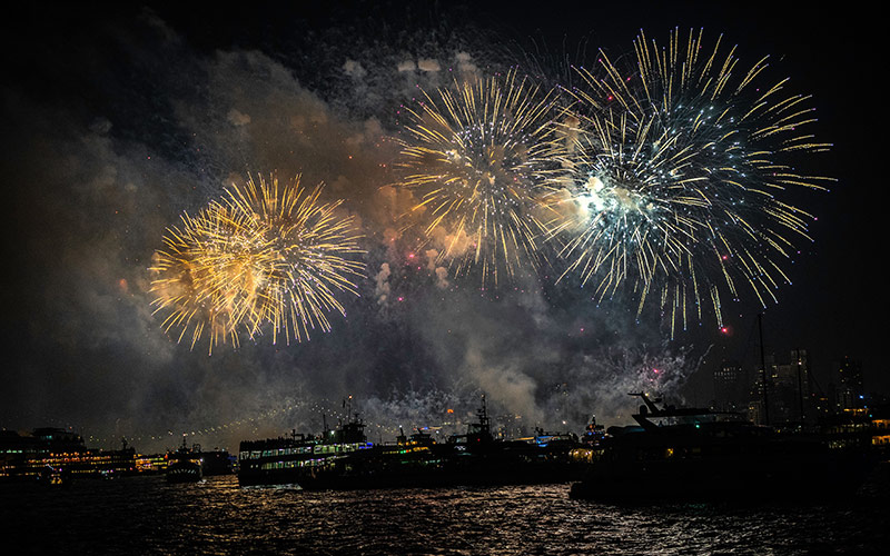 a large assortment of fireworks, being shot in the sky, with boats overlooking the view