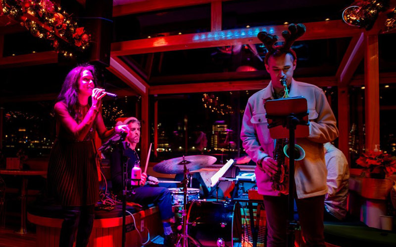 Live band playing holiday music for an evening cruise aboard the yacht Manhattan II