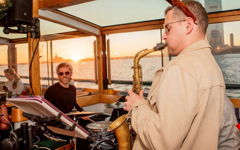 a group of musicians, playing music aboard the yacht manhattan