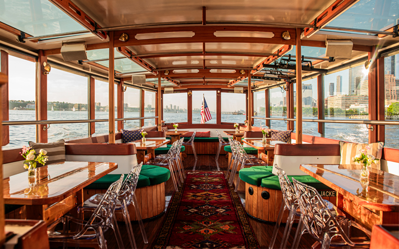 main salon of yacht Manhattan showcasing the tables and windows
