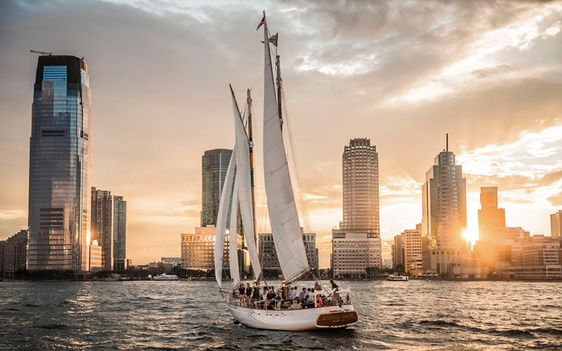 Schooner Adirondack at Sunset with the New Jersey Skyline in the background sailing on the Hudson River.