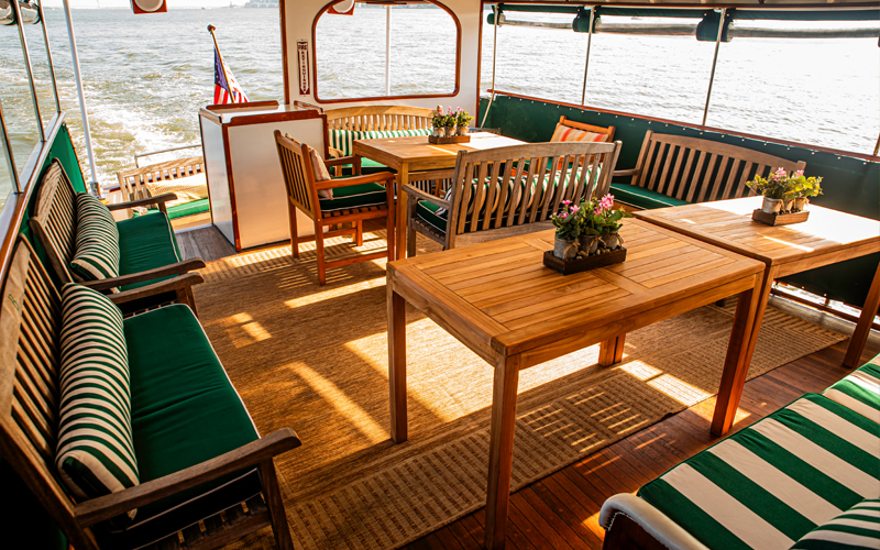 Back cabin of yacht Full Moon showcasing the tables and seating