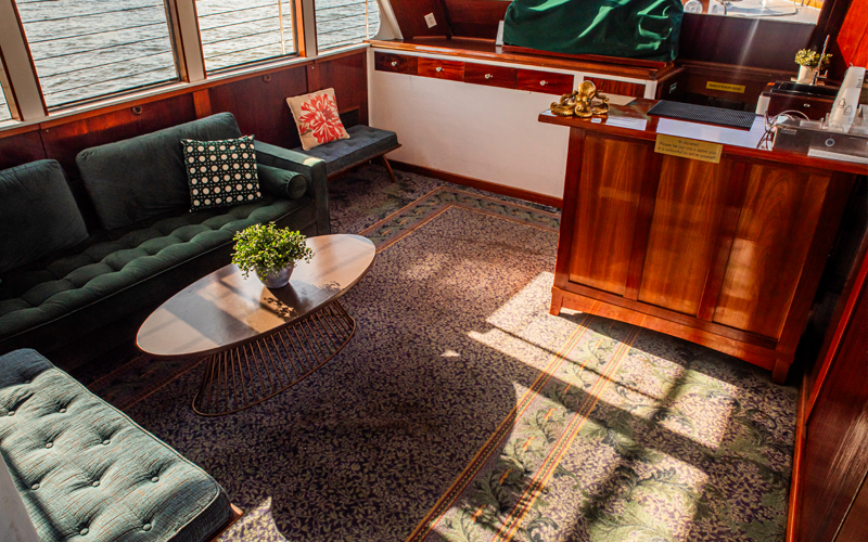 Interior lounge of the yacht Full Moon showcasing seating and a bar