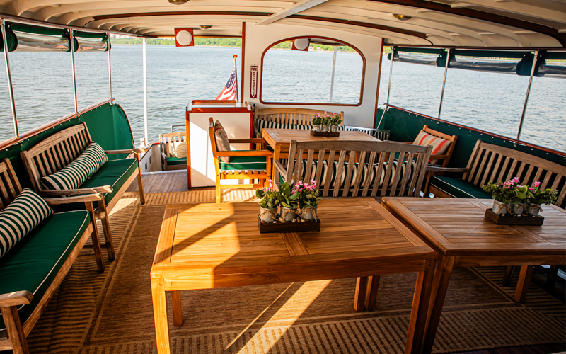 Back cabin of yacht Full Moon showcasing the tables and seating