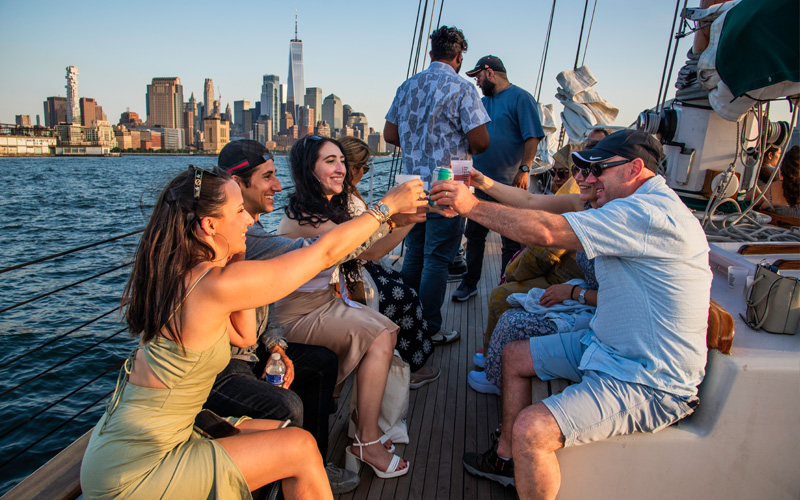 Guests on the deck of schooner America 2.0 in NY Harbor