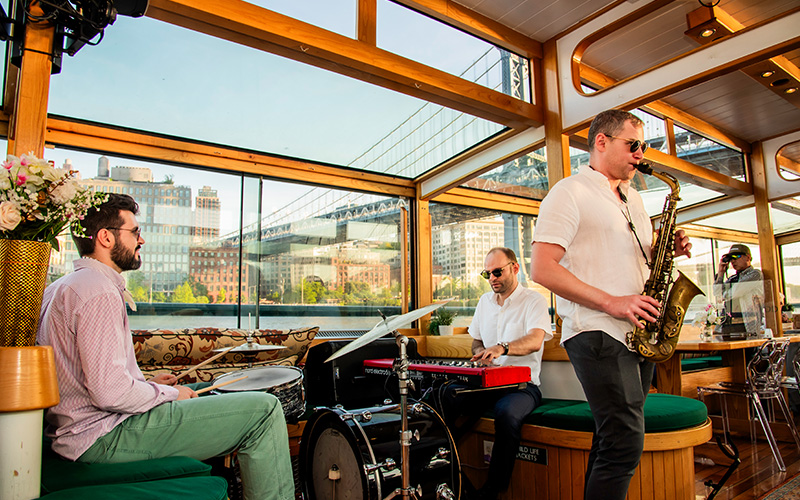 Three person Jazz Band playing on a boat in NY Harbor