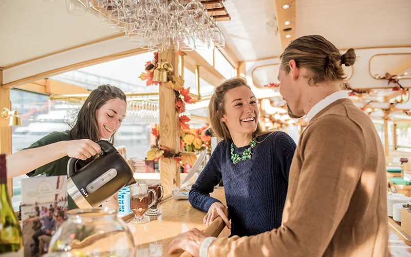 Couple getting drinks on a classic yacht for a Fall Foliage Cruise