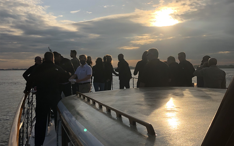 Guests on the bow of yacht Full Moon at Sunset