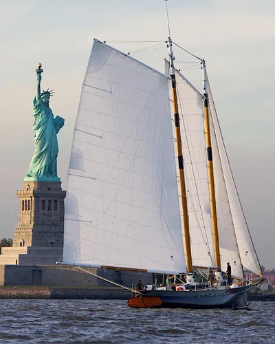 Schooner America 2.0 Sailing in front of the Statue of Liberty