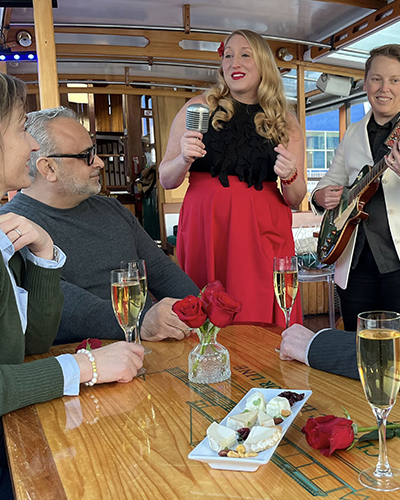Singer and guitarist performing for a couple on a boat for Valentine's Day