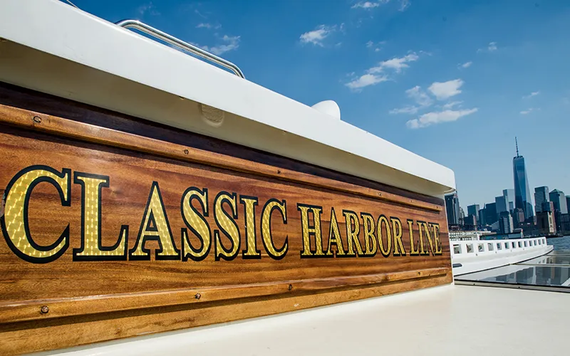 Easter9 Classic Harbor Line signed on the yacht Manhattan boat with the world trade center in the background in NY Harbor
