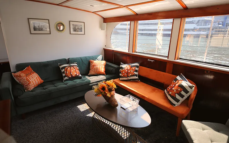 The interior lounge of yacht Full Moon with chairs, couch and table