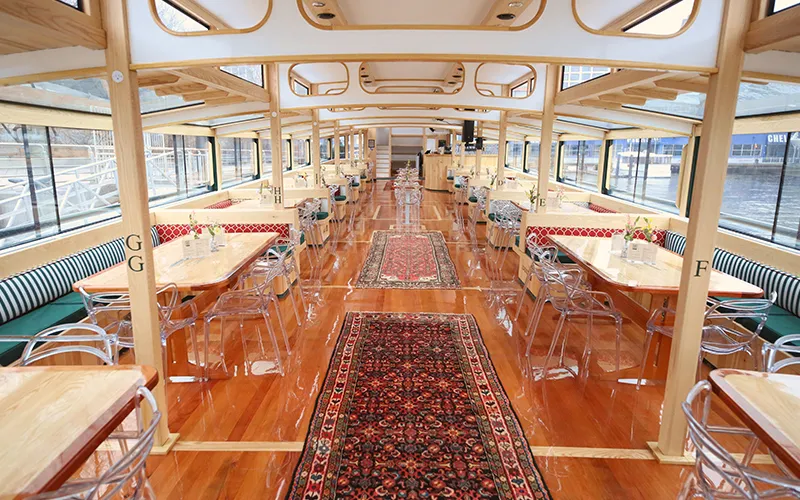 Grand Salon of the Yacht Manhattan III showcasing the windows, tables and chairs