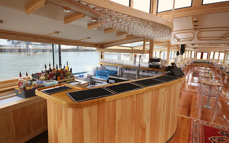 Grand Salon of the Yacht Manhattan III showcasing the windows, tables and chairs