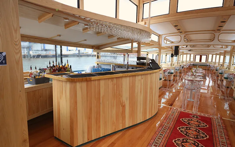 Grand Salon of the Yacht Manhattan III showcasing the windows, tables and chairs