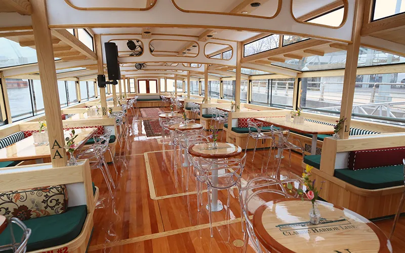 Grand Salon of the Yacht Manhattan III showcasing the windows, tables and chairs