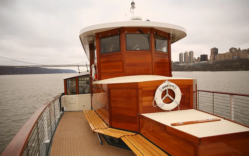 The bow of yacht Manhattan with the George Washington Bridge in the background