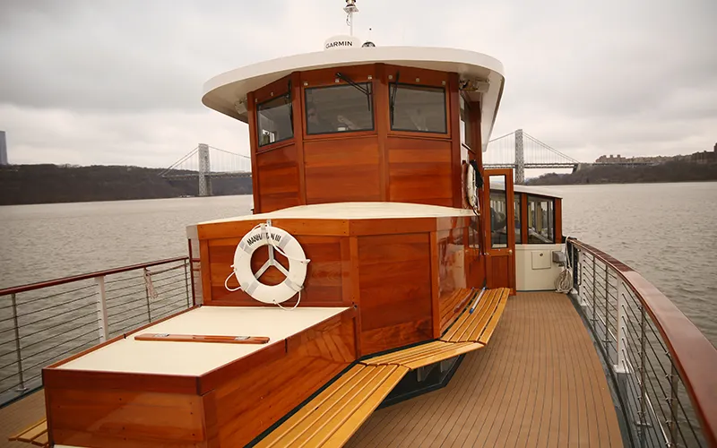 The bow of yacht Manhattan with the George Washington Bridge in the background