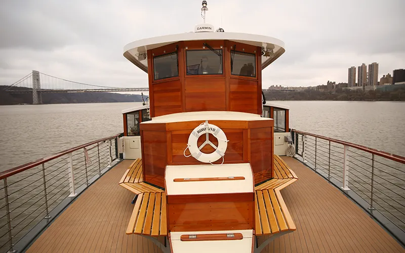 The bow of yacht Manhattan with the George Washington Bridge in the background