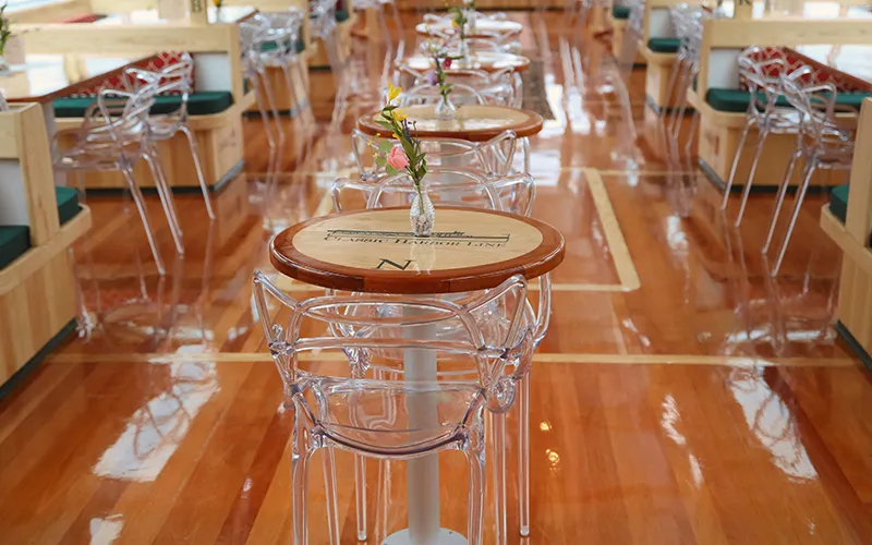 Grand Salon of the Yacht Manhattan III showcasing the windows, tables and chairs
