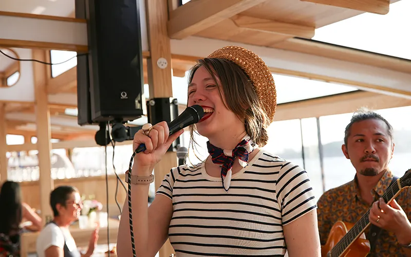 CaitJones2 woman singing on a boat