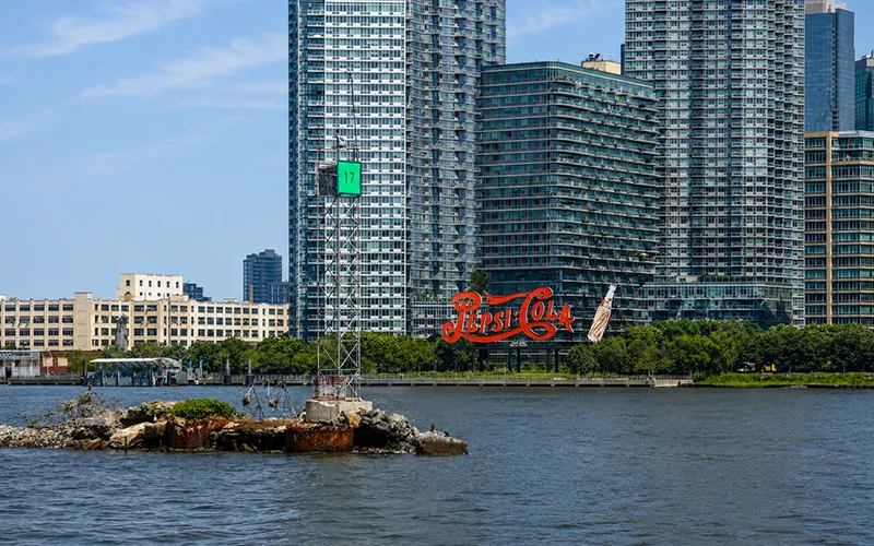 Unframed7 The Pepsi Cola sign and a nautical marker from the perspective of the water.