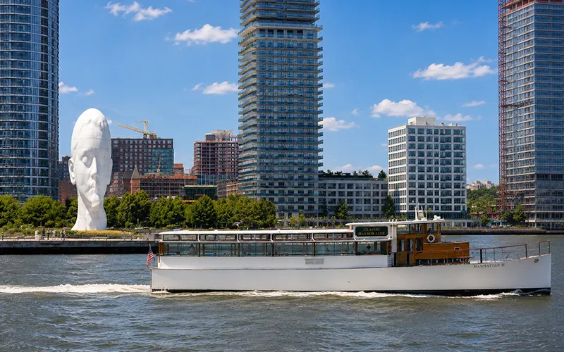 Sculpture on the Hudson River with a boat passing in front of it