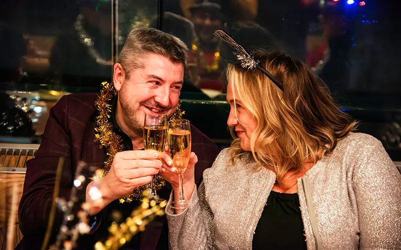 NewYear5 A couple clinking champagne glasses