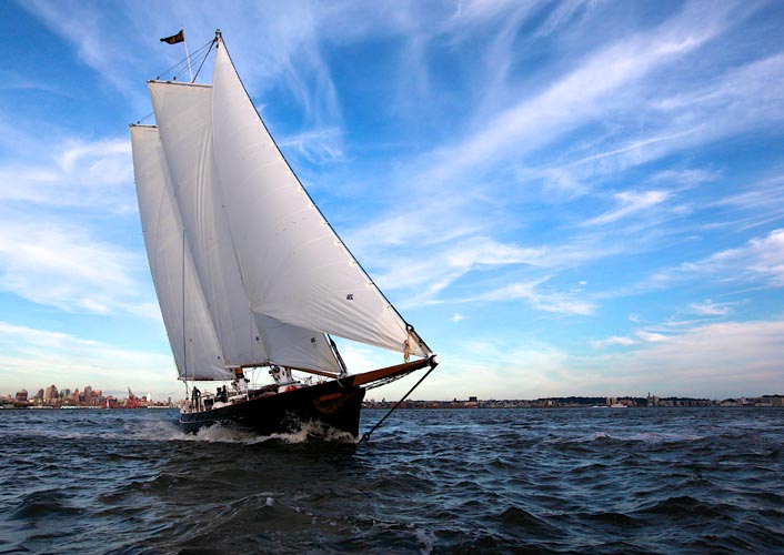 Full boat photo of Schooner America 2.0 healing while sailing in NY Harbor