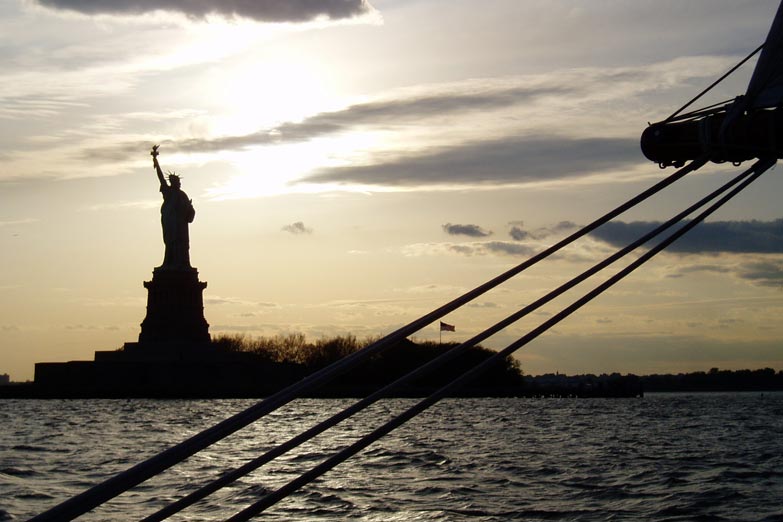 silhouette of the Statue of Liberty at Sunset aboard the stern of Schooner Adirondack
