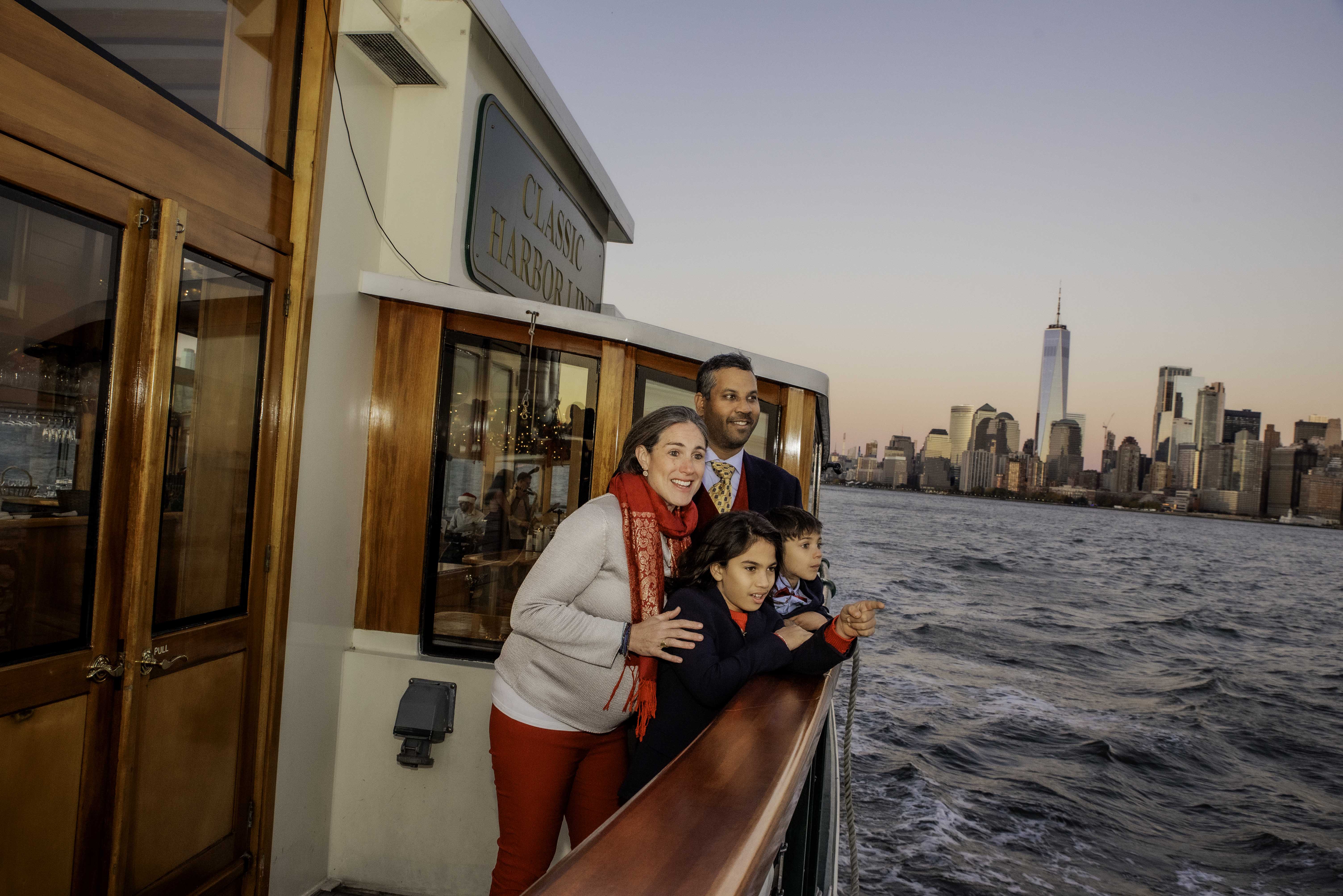 Family on the deck of Yacht Manhattan II for a NYC Sightseeing cruise for the Holiday season