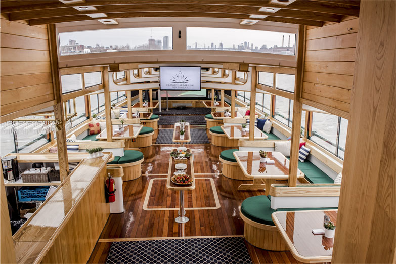 Interior photo of the Yacht Manhattan II main salon where the tables and skylights are showcased 
