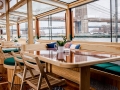 Interior shot of Yacht Manhattan II tables with the Brooklyn Bridge showcased in the background 