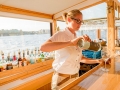 Crew Member serving Champagne behind the bar aboard the Yacht Manhattan II