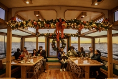 Small gathering for a holiday cruise on yacht Manhattan II with holiday decor