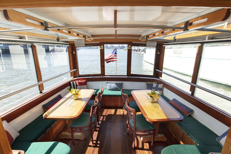 Two back private tables at the aft portion of the boat aboard the Yacht Manhattan 