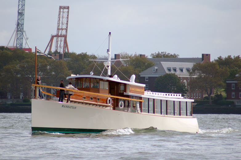 Full boat photo of Yacht Manhattan cruising past Governors Island in NY Harbor
